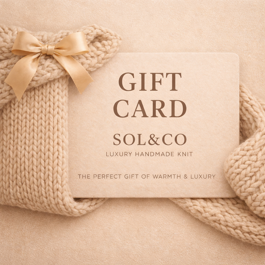 Gift card with 'SOL&CO' branding on a knitted blanket. chunky chenille knit blanket packaged as gift card
