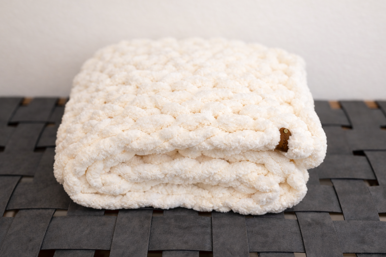 Taupe chunky chenille knit blanket 24x30 styled on neutral close texture