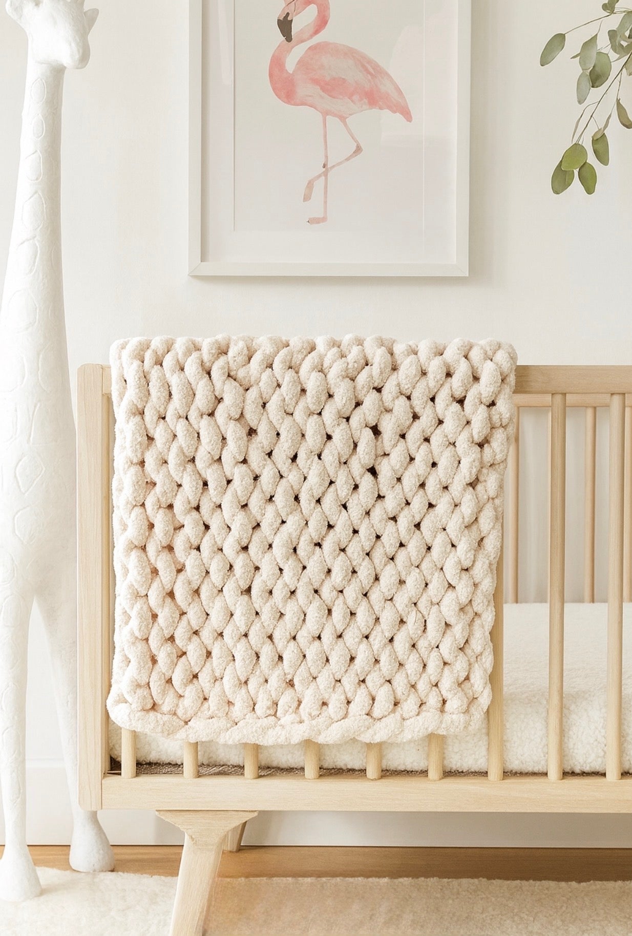 French vanilla chunky chenille knit blanket folded in crib